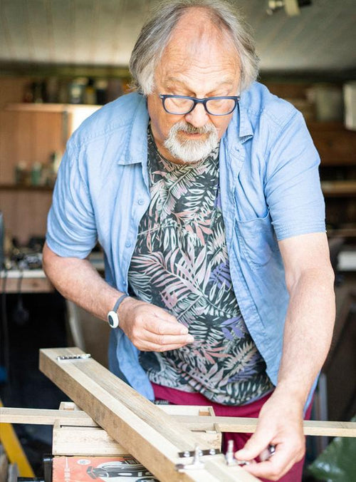 Personal alarm pendant worn by elderly man