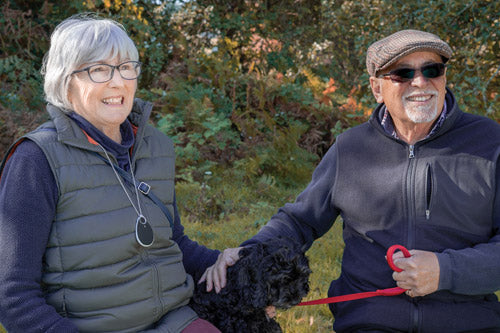 Elderly couple wearing GPS emergency alarm around the neck