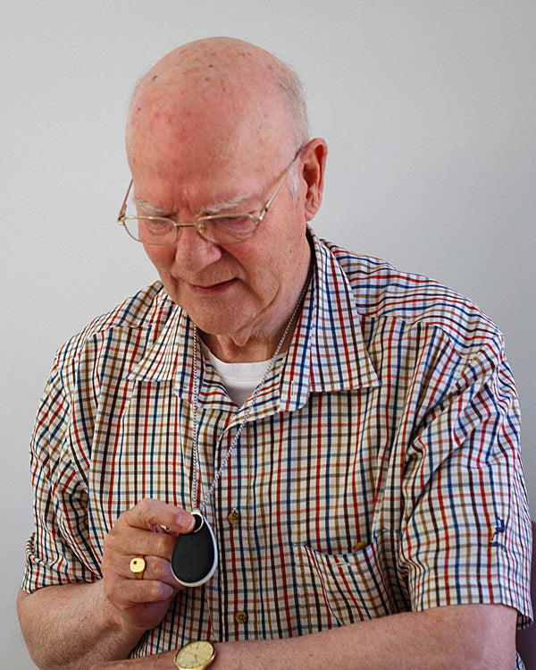 Elderly man pressing Taking Care Anywhere pendant button
